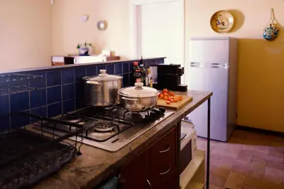 a kitchen with two pots and pans on a stove at In Torre Palazzo Orioles in Palermo