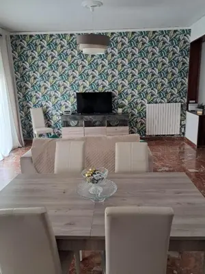 a dining room with a wooden table and chairs at Casa Kennedy in Capaci