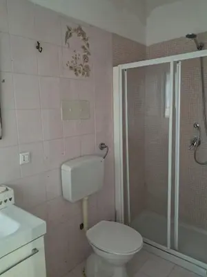 a bathroom with a toilet and a shower and a sink at Casa Kennedy in Capaci
