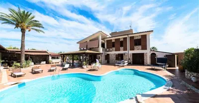 a swimming pool in front of a house at Villa Aversa in Castellammare del Golfo