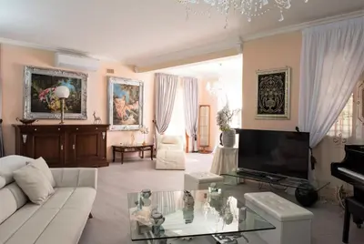 a living room with a white couch and a piano at Villa Aversa in Castellammare del Golfo