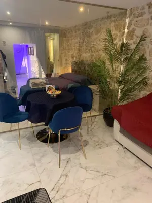 a dining room with a table and blue chairs at Ai Chiavettieri Suite in Palermo