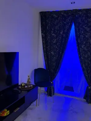a blue room with a chair and a table at Ai Chiavettieri Suite in Palermo