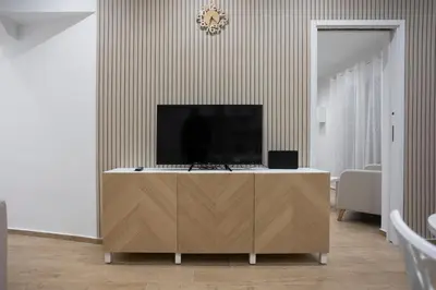 a living room with a tv on top of a cabinet at Dominic Luxury House - a 2 passi dalla cattedrale in Palermo