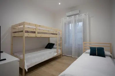 a bedroom with two bunk beds and a window at Dominic Luxury House - a 2 passi dalla cattedrale in Palermo