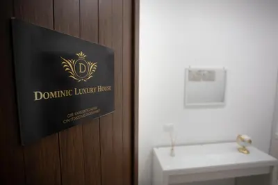 a sign on a door in a bathroom with a sink at Dominic Luxury House - a 2 passi dalla cattedrale in Palermo