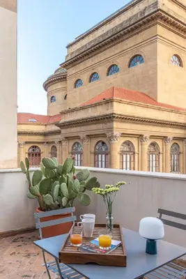 a table with two oranges on it in front of a building at La Terrazza sul Massimo in Palermo