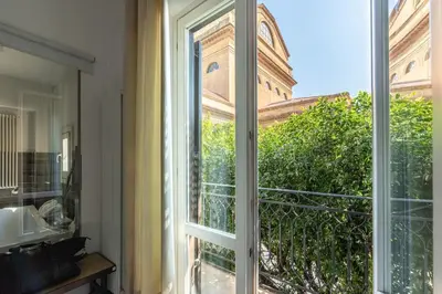an open window with a view of a building at La Terrazza sul Massimo in Palermo