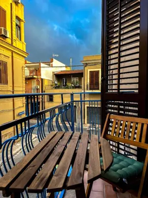 a wooden bench sitting on top of a balcony at B&B Il Mare di Terrasini in Terrasini