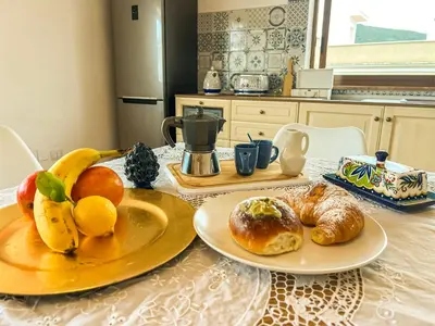 a table with two plates of fruit and bread on it at B&B Il Mare di Terrasini in Terrasini