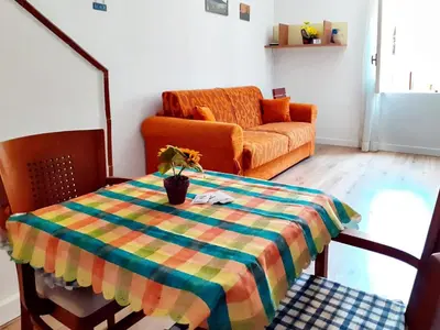 a living room with a table and a couch at Don Vito's Apartments in Castellammare del Golfo