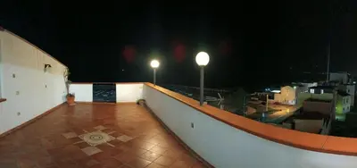 a balcony with two lights on top of a building at night at Casa la B a n d i t a in Palermo