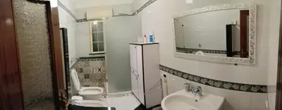 a bathroom with a sink and a toilet and a mirror at Casa la B a n d i t a in Palermo