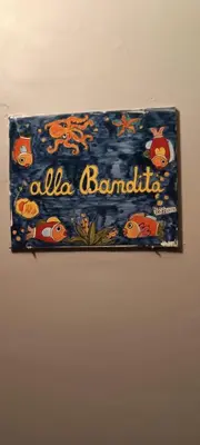 a sign on a wall that says allaa bandania at Casa la B a n d i t a in Palermo