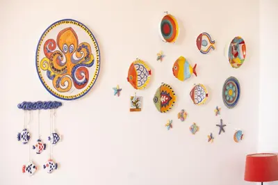 a wall with plates and clocks on a wall at La Bougainvillea casa vacanze in Alcamo