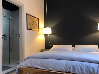 a bedroom with a large bed with two pillows at Casa Mamma Bruna in San Vito lo Capo