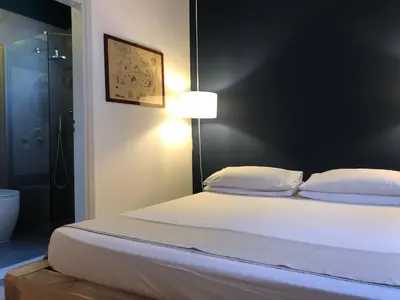 a bedroom with a bed and a glass shower at Casa Mamma Bruna in San Vito lo Capo
