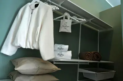 a room with a shelf with towels and towels at Chez Moi in Palermo