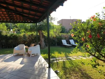 a group of chairs sitting on a patio at Casa delle Salinelle in Lascari