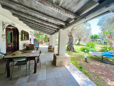 an outdoor patio with a table and chairs at Villa Ólea Resort in Carini