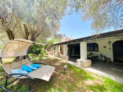 a yard with a chair and a house at Villa Ólea Resort in Carini