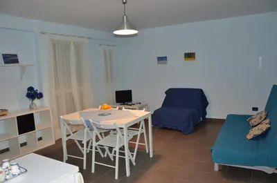 a living room with a table and chairs and a couch at Case Vacanze Himera in Termini Imerese