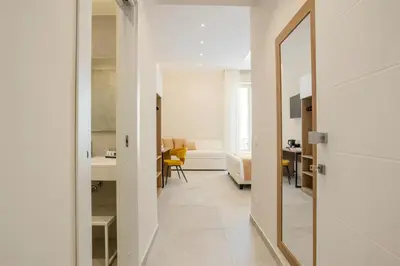 a hallway leading to a room with a mirror at Julia's Boutique Rooms in Palermo
