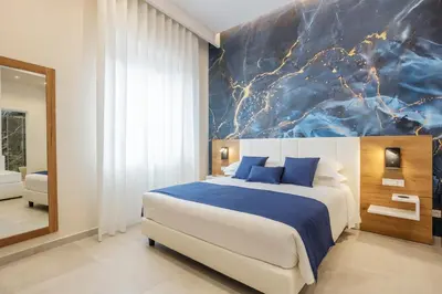 a bedroom with a large bed with green pillows at Julia's Boutique Rooms in Palermo