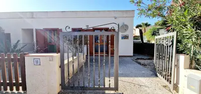 an open gate in front of a house at Green House con piscina privata 7 posti in Macari