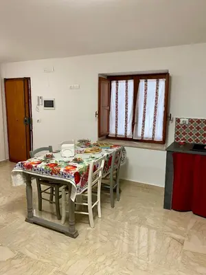 a dining room table with chairs and a table cloth at La mia Casetta al Politeama in Palermo