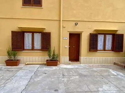 a building with windows and potted plants in front of it at La mia Casetta al Politeama in Palermo