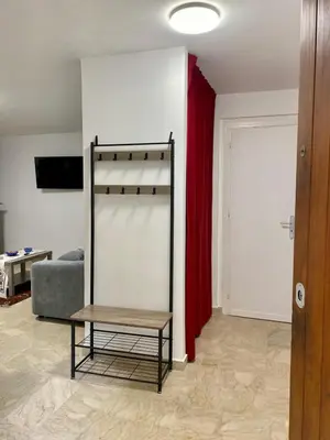 a room with a bed and a table and a red curtain at La mia Casetta al Politeama in Palermo