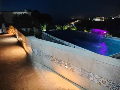 a swimming pool on the side of a building at night at Villa Stella in Alcamo