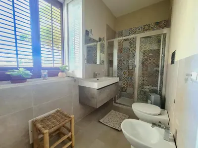 a bathroom with a sink and a toilet and a tub at B&B Ondamarina in Lascari