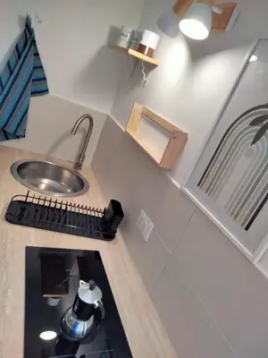 a small kitchen with a sink and a counter at Casa Nadir in Palermo