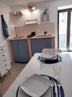 a kitchen with a table with white plates and utensils at Casa Nadir in Palermo