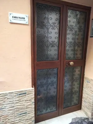 a door to a building with a sign on it at Casa Nadir in Palermo