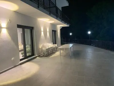 a balcony with a bench on a building at night at Trabia Casa Bianca B in Mandra Capreria