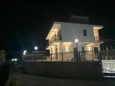 a white house at night with lights on it at Trabia Casa Bianca B in Mandra Capreria
