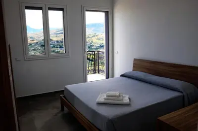a bedroom with a bed with two towels on it at Trabia Casa Bianca B in Mandra Capreria