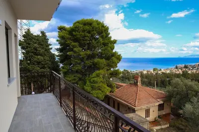a balcony of a house with a view of the ocean at Trabia Casa Bianca B in Mandra Capreria