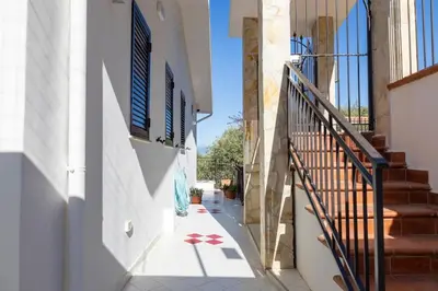 a hallway of a house with stairs and a stair case at Trabia Villa Bedda Mia B in Trabia