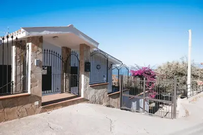 a building with a gate and a fence at Trabia Villa Bedda Mia B in Trabia