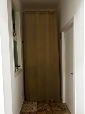 a closet with a curtain in a room with a door at Casa Sulia in Terrasini