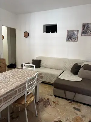 a living room with a couch and a bed at Casa Sulia in Terrasini