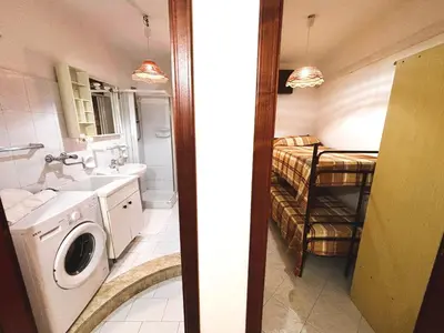 a bathroom with a sink and a washing machine at Casa Amodei 1 a pochi passi dal mare in San Vito lo Capo