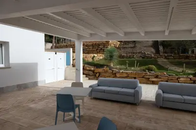 a patio with two couches and a table and chairs at Le Onde della Sicciara in Balestrate