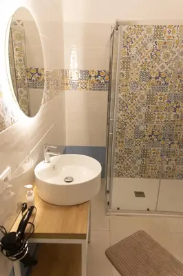 a bathroom with a sink and a shower at Le Onde della Sicciara in Balestrate