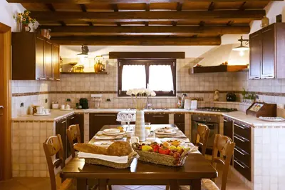 a kitchen with a table with a bowl of fruit on it at Villa Palme in Alcamo Marina