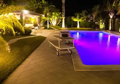 a swimming pool at night with purple lights at Villa Palme in Alcamo Marina